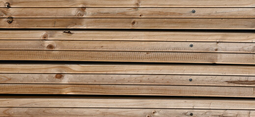 Fondo con detalle y textura de varios listones de madera, con tonos marrones, vetas y nudos.