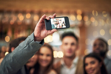 Selfie, event or party group of people in restaurant for happy night celebration, mobile influencer and bokeh lights. Profile picture, hand holding and smartphone screen of friends for social media