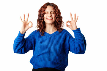 Cute millennial woman wearing pullover sweater standing isolated over white background showing two...