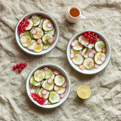 Radish and cucumber salad served in round bowls, decorated with red currants