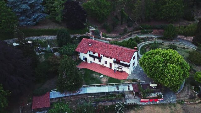 Drone shot of hotel complex L'Uovo e la Faina near Cuneo, Italy. Tilt down view.