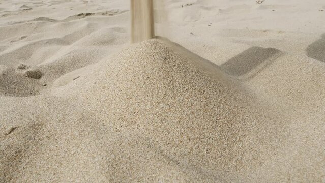 Falling sand forms a pile. Falling sand forms a pile