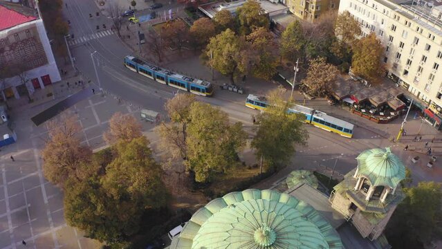 City transport in Sofia, Bulgaria at Sveta Nedelya Square with a view of the mountain and the pedestrian street Vitoshka.