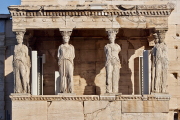 Caryatids, women figures statues at Erechtheion ancient Greek temple, on Acropolis hill. Cultural travel in Athens, Greece. - obrazy, fototapety, plakaty