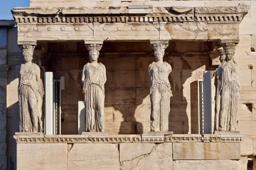 Fotobehang Caryatids, women figures statues at Erechtheion ancient Greek temple, on Acropolis hill. Cultural travel in Athens, Greece. © Dimitrios