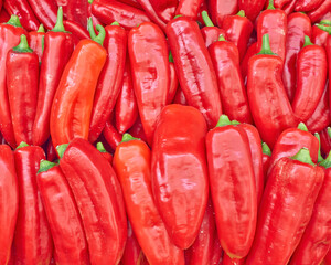 Vibrant red organic peppers for sale top view close up. A natural, colorful background.