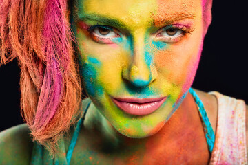 Mysterious sensual woman covered in rainbow colored powder. Colors Holi festival. Beauty spring...