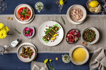 Food Table Celebration Delicious Party Meal Concept. A lot of food on the table: meat, dolma, khachapuri, manti.  Foodset from Georgian dishes. 