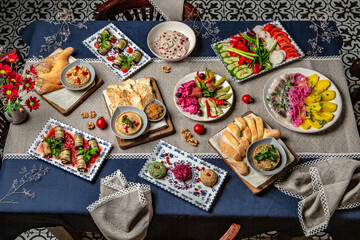 Fototapeta na wymiar Food Table Celebration Delicious Party Meal Concept. A lot of food on the table: meat, dolma, khachapuri, manti. Foodset from Georgian dishes. Caucasian food
