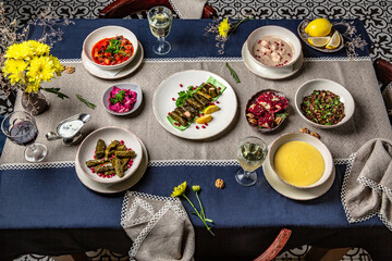 Food Table Celebration Delicious Party Meal Concept. A lot of food on the table: meat, satsivi, pkhali, dolma, khachapuri, manti.  Foodset from Georgian dishes. Caucasian food