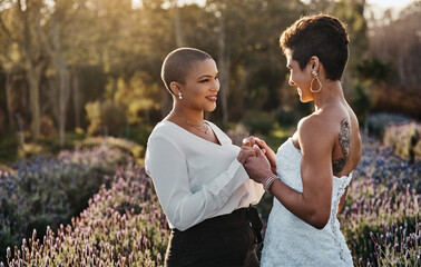 Woman, lesbian couple and holding hands in marriage for wedding with smile for LGBT relationship in...