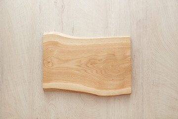 wooden cutting board on wood table, mockup, soft light