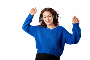 Obraz na płótnie Canvas Cute woman wearing blue knitted sweater standing isolated over white background listen music with headphones, dancing. Dancing to favorite music is very happy. Enjoys it very much.