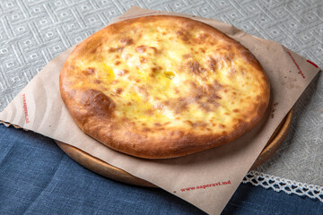 Traditional Georgian Adjara khachapuri, manti and Kolkh khachapuri on the table. Food Table Celebration Delicious Party Meal Concept. 