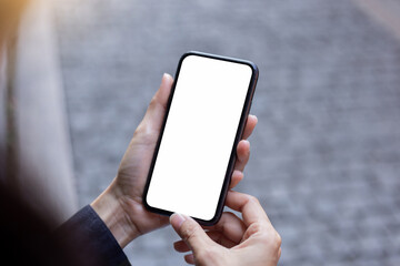 Fototapeta na wymiar cell phone blank white screen mockup.hand holding texting using mobile on desk at office.background empty space for advertise.work people contact marketing business,technology