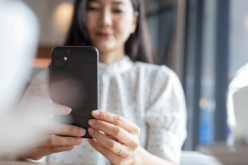 woman using cell phone hand holding mobile texting message contact us.chatting,search internet information.technology device communication connecting