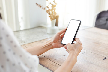 cell phone blank white screen mockup.hand holding texting using mobile on desk at office.background empty space for advertise.work people contact marketing business,technology