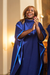 Portrait of Cheerful African American Woman in Blue Robe in Sunday Church. Black Christian Female...