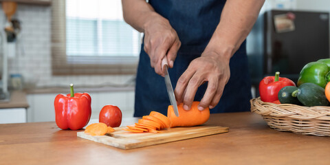 Man preparing delicious and healthy food in the home kitchen