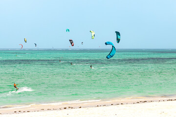 Kite surfing in ocean in Paje beach, Zanzibar, Tanzania. Extreme summer water sport, acitve holiday