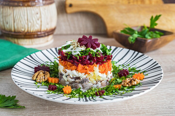 Layered salad with beets, carrots and herring