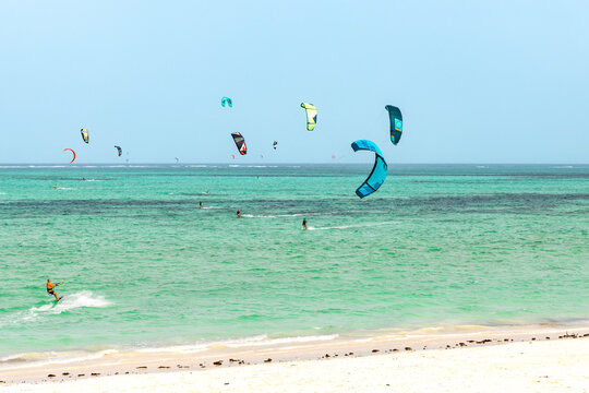 Kite surfing in ocean in Paje beach, Zanzibar, Tanzania. Extreme summer water sport, acitve holiday