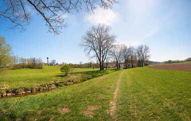 Fototapeta na wymiar walkway along a brook from Schwindegg to Obertaufkirchen in spring