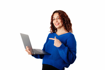 Cute caucasian woman wearing blue pullover sweater isolated over white background pointing index finger on laptop pc computer looking camera.