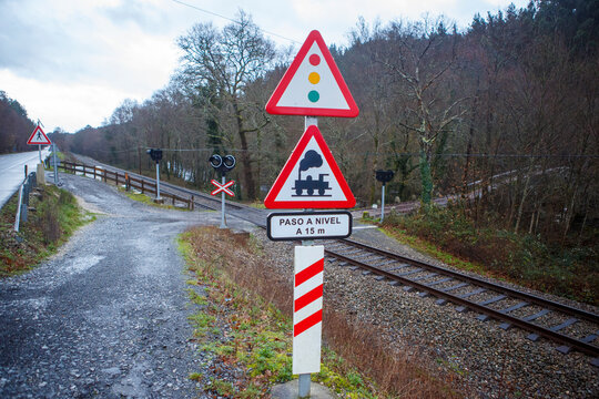 railway level crossing with warning signs that indicate the passage of trains
