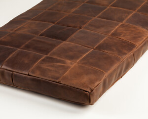 Decorative seat cushion from brown leather patches