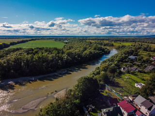 Fototapeta premium Aerial vIew of Zhudachiv city by drone. Summer Ukraine Lviv region, West Ukraine. River.