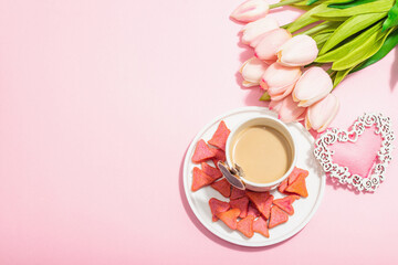 Obraz na płótnie Canvas Valentine's Day romantic concept. Morning coffee, a bouquet of tulips, symbolic decor