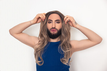 Cute travesty man using the false hair