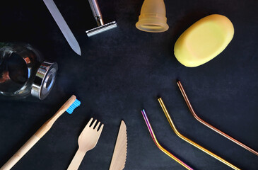 Various sustainable beauty products and kitchen utensils on dark background. Top view.