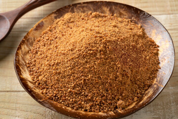 Coconut bowl with golden palm sugar close up