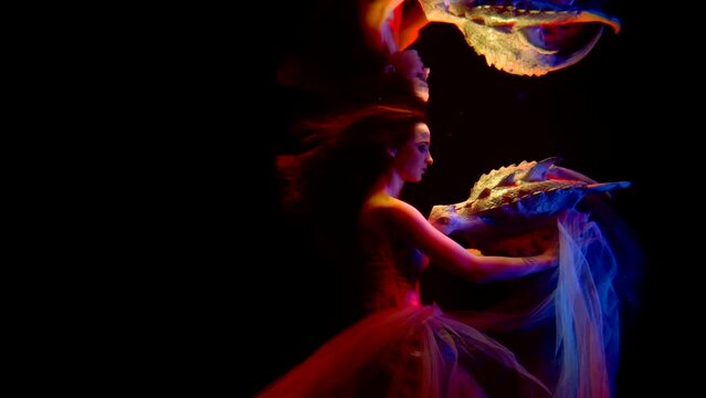 princess and her tamed dragon are swimming in mysterious dark depth of sea or ocean