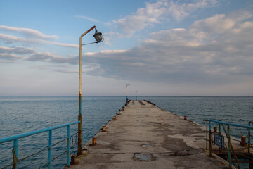 Old empty pier in blue sea. Koktebel. Crimea