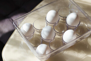 blank white eggs in the plastic box. preparing for easter