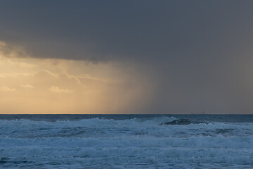 White sea waves and cloudy skyscape in the evening