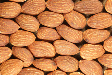 Top view of raw almonds pie background