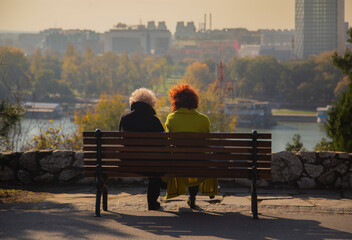 Belgrade, Serbia. November 10th, 2022. Two female friends sitting on a bench at the Kalemegdan park...