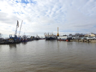 cranes in the harbor of kaliningrad, russia, on the river pregolya