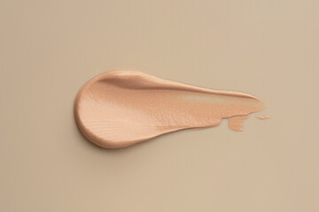The texture of the foundation on a beige background