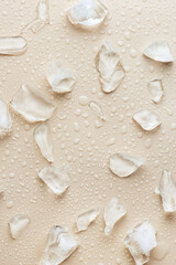 Fototapeta na wymiar Water drops and ice on a beige background