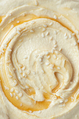 Macro texture of cooked chickpea hummus with sesame seeds