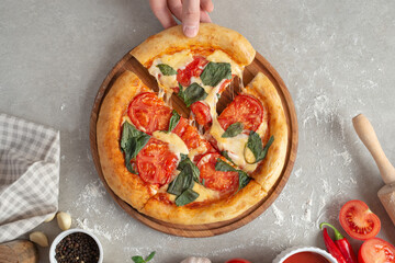 The process of making margarita pizza. Male hands, top view. Tomato paste with cheese.