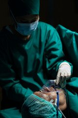 Anesthesiologist wearing a mask to anesthetize the patient for surgery.