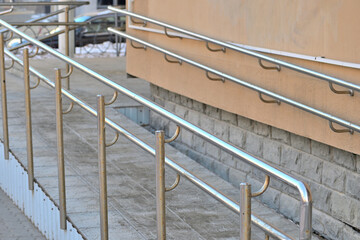 Ramp for the disabled at the entrance to the building on a winter day