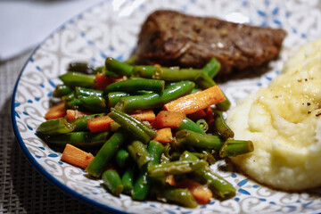 Potatoes with meat and vegetables on the table