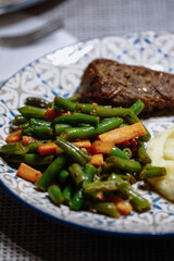 Potatoes with meat and vegetables on the table